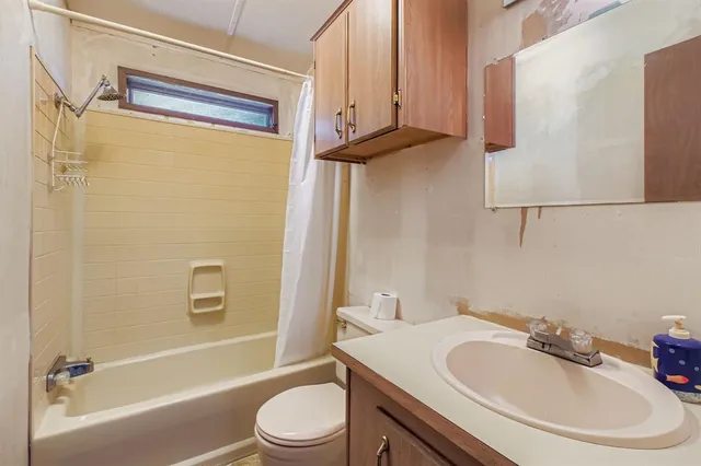 a bathroom with a sink a toilet and a bathtub