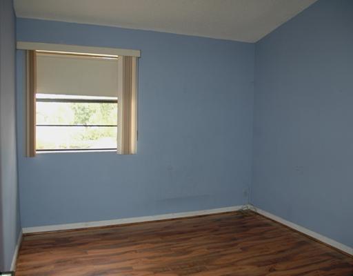 6347 Toulon Drive Boca Raton, FL 33433 - Photo 19 of 24 a view of an empty room with wooden floor and a window