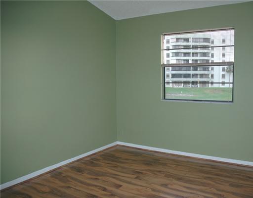 6347 Toulon Drive Boca Raton, FL 33433 - Photo 21 of 24 a view of an empty room with wooden floor and a window