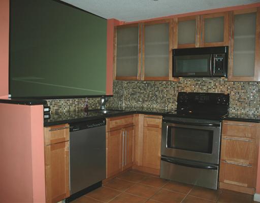 6347 Toulon Drive Boca Raton, FL 33433 - Photo 4 of 24 a kitchen with granite countertop white cabinets and stainless steel appliances