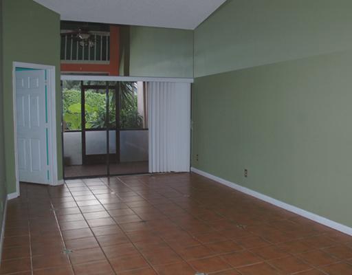 6347 Toulon Drive Boca Raton, FL 33433 - Photo 8 of 24 wooden floor in an empty room with a window