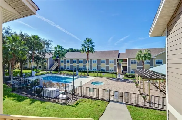 a view of an house with backyard and patio
