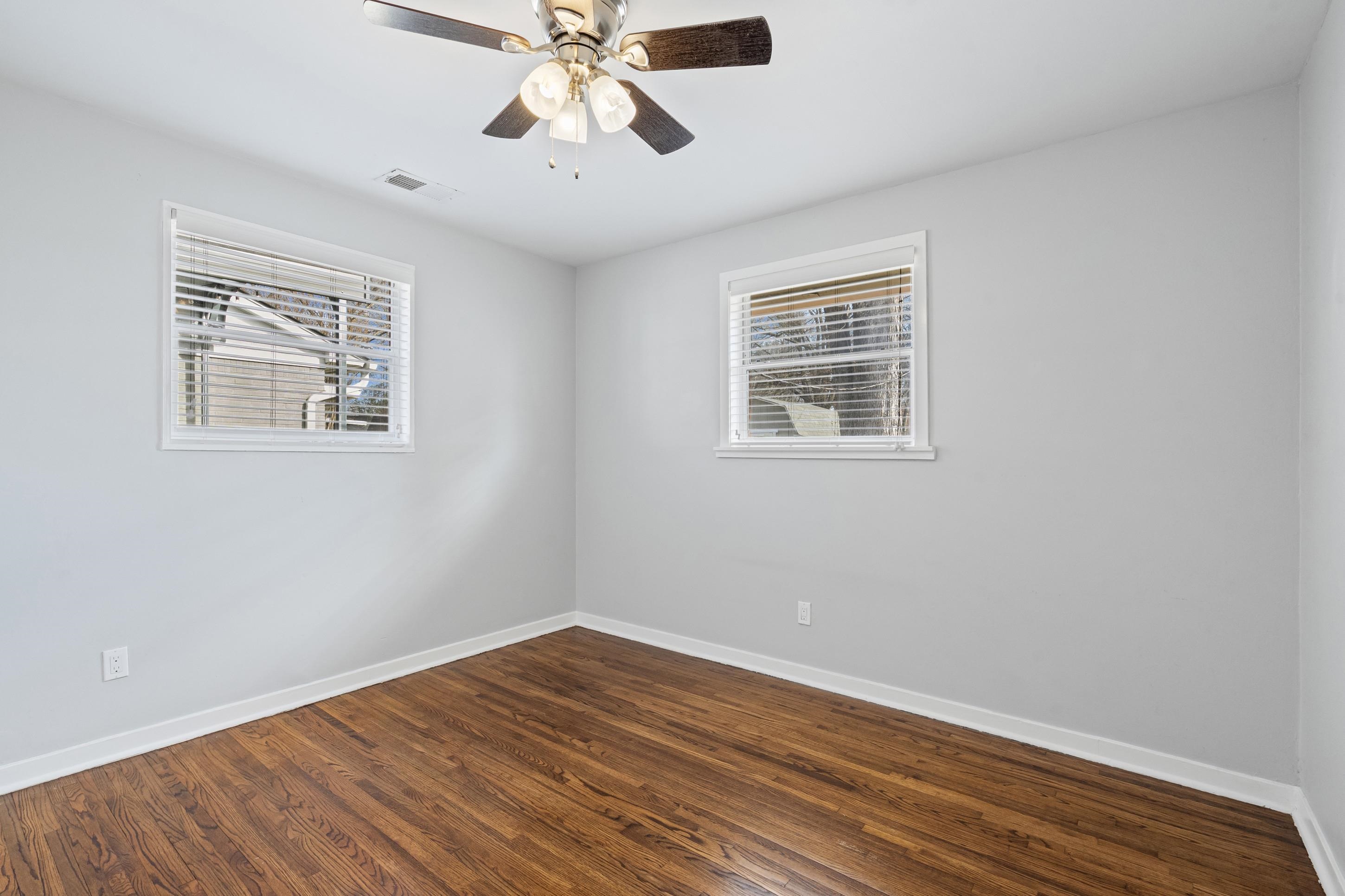 506 McDermitt Road Memphis, TN 38120 - Photo 13 of 29 Unfurnished room with dark wood-style flooring and a ceiling fan
