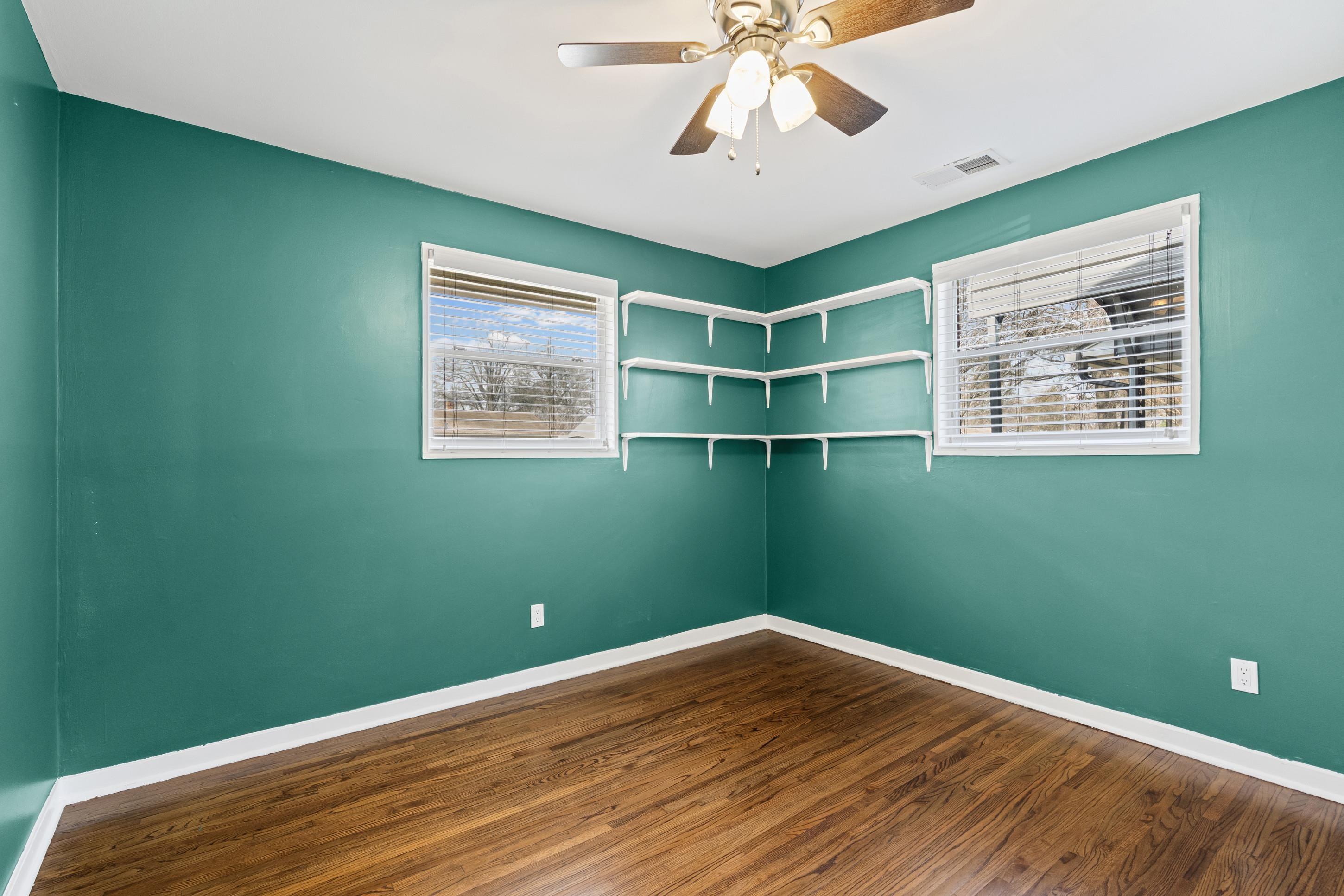 506 McDermitt Road Memphis, TN 38120 - Photo 17 of 29 Empty room featuring ceiling fan and dark wood-type flooring
