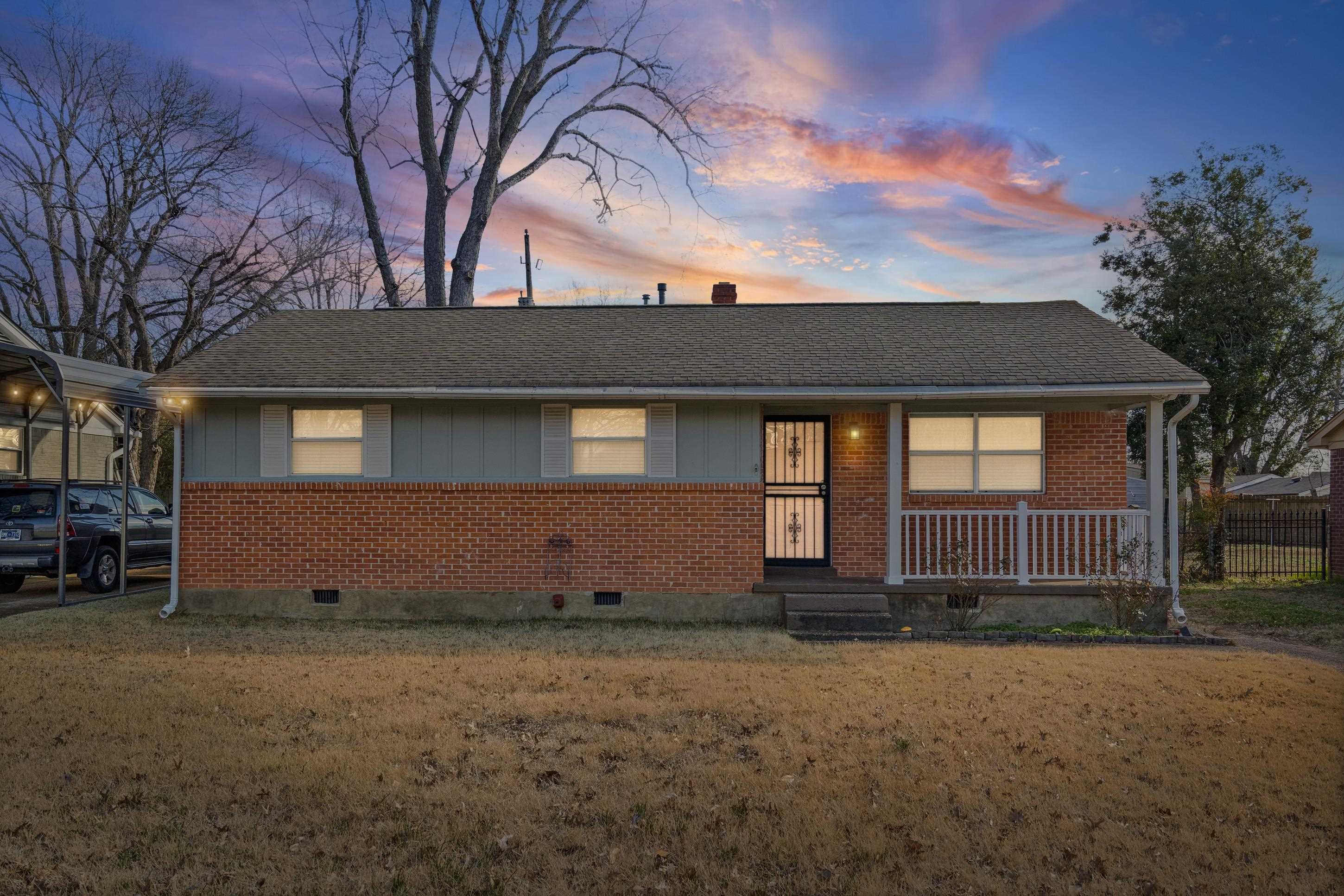 506 McDermitt Road Memphis, TN 38120 - Photo 2 of 29 View of front of home featuring brick siding, crawl space, covered porch, and a yard