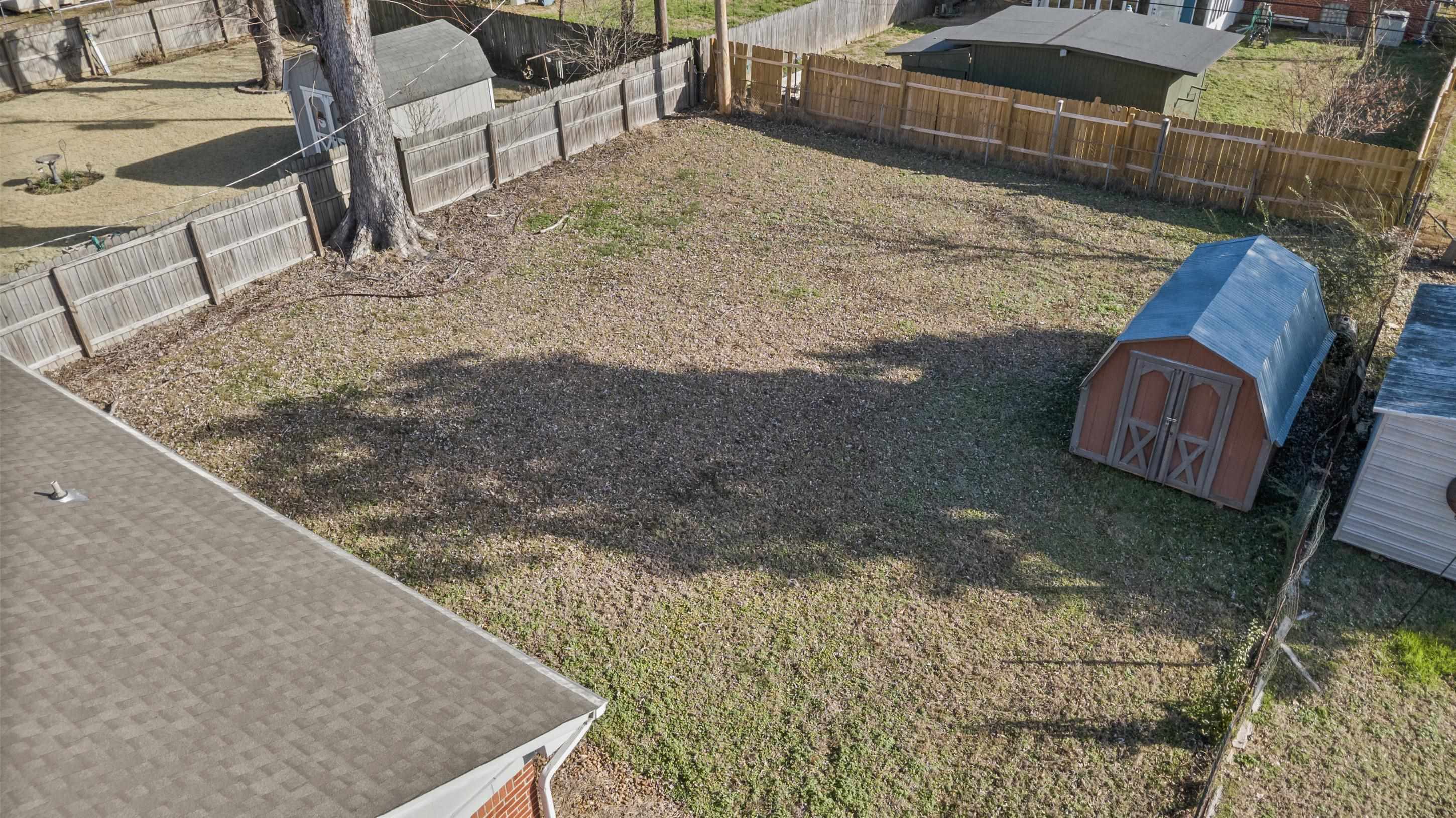 506 McDermitt Road Memphis, TN 38120 - Photo 24 of 29 Fenced backyard with a shed