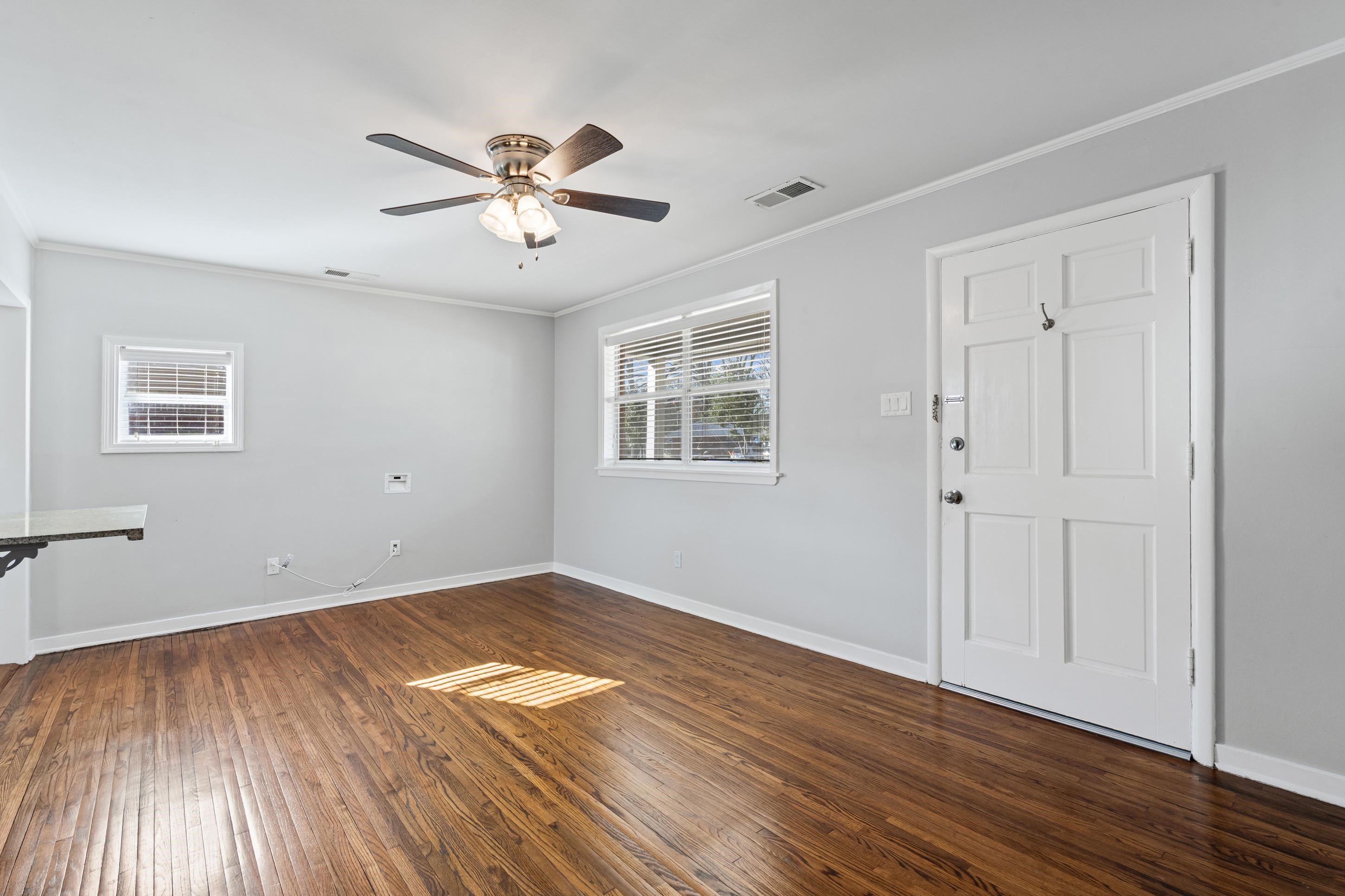 506 McDermitt Road Memphis, TN 38120 - Photo 6 of 29 Unfurnished room featuring dark wood finished floors, ceiling fan, and crown molding