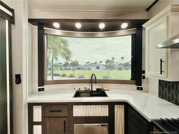 a view of a white house with a yard