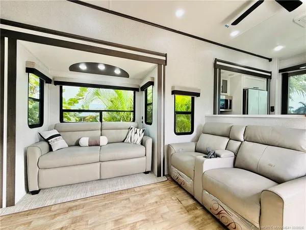 a living room with a fireplace and a large window