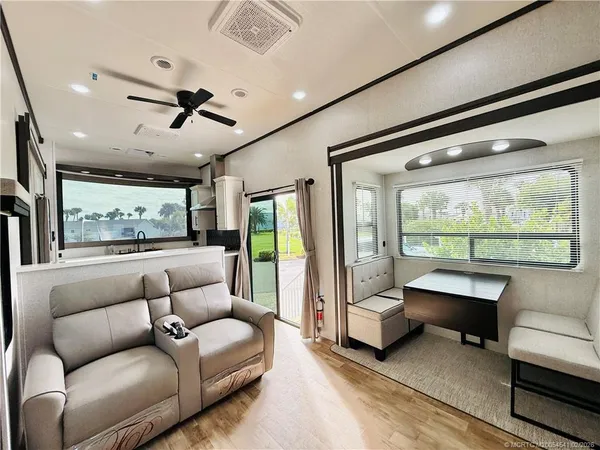 a bathroom with a granite countertop shower sink vanity and mirror