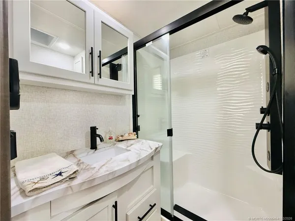 a bathroom with a sink a toilet and vanity