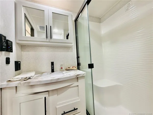 a bathroom with a sink toilet and mirror