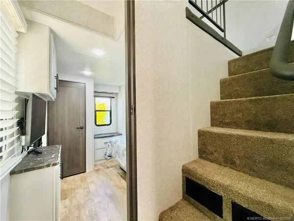 a bedroom with a large bed and a large mirror