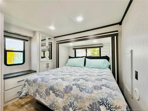 a bedroom with a bed and mirror