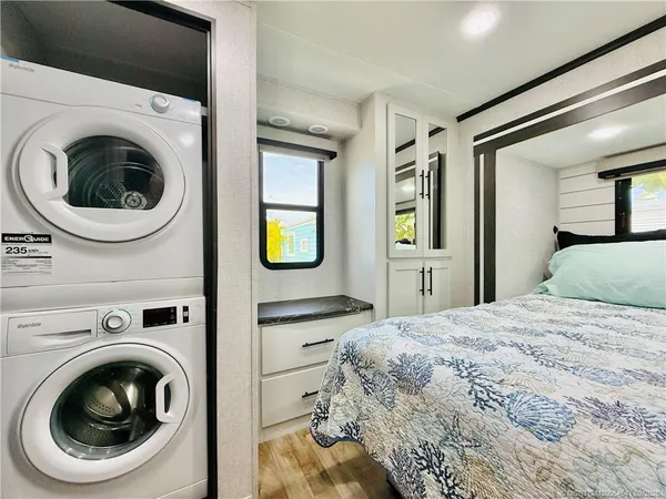 a bedroom with a bed and a large window