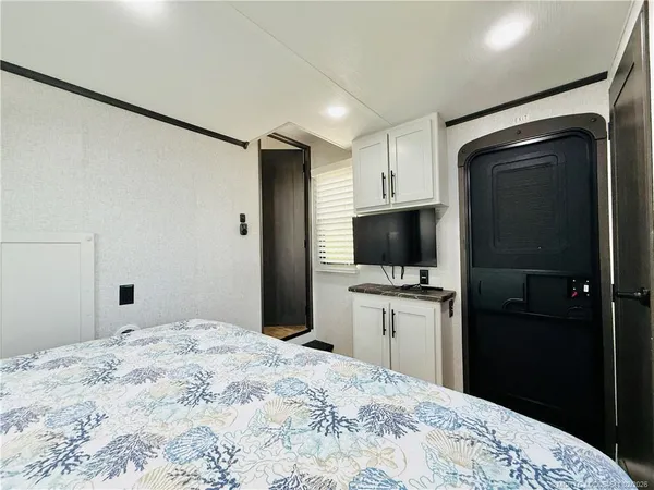 a view of a kitchen with microwave and refrigerator