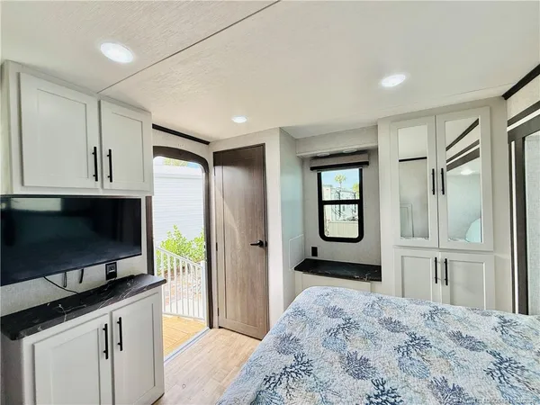 a bedroom with a bed and a dresser in it