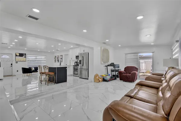 a living room with furniture a table and chairs