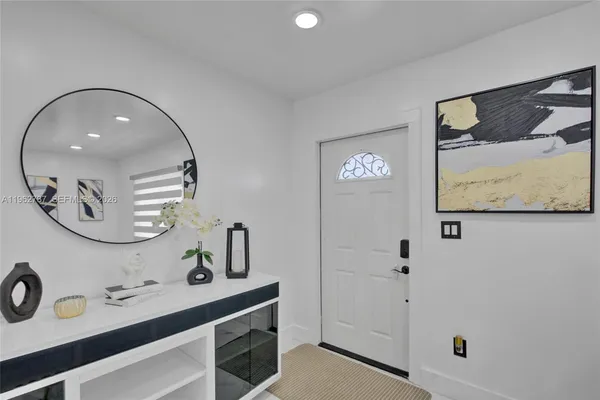 a bathroom with a sink mirror and vanity