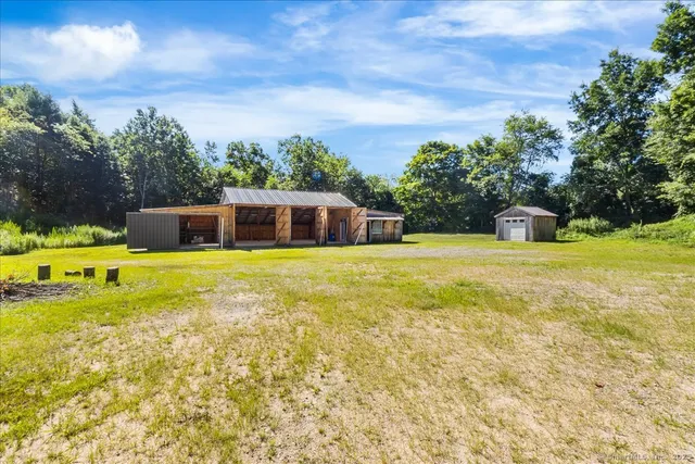 a swimming pool with outdoor seating and yard