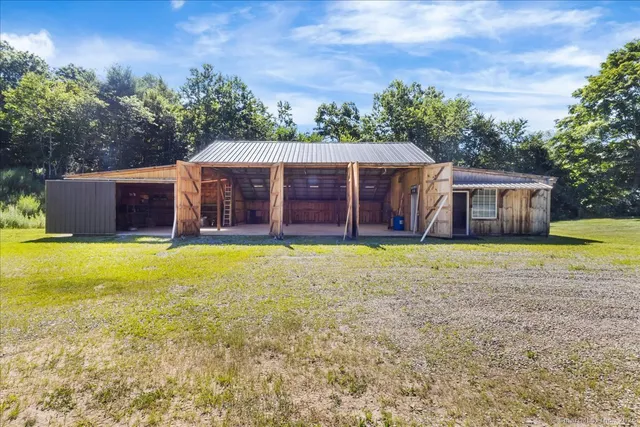 a view of a house with a yard and tree s