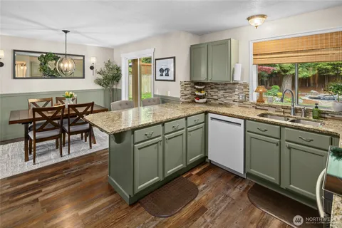 a kitchen with a sink cabinets and wooden floor