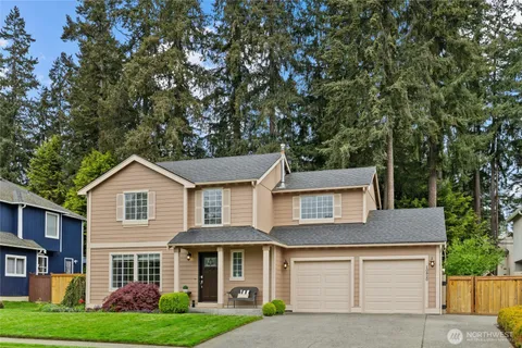 a front view of a house with a yard and garage