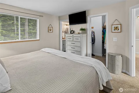 a bedroom with a flat screen tv and a bed