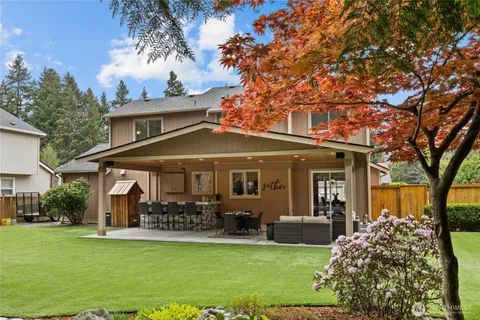 a dining hall with stainless steel appliances a sink table and chairs