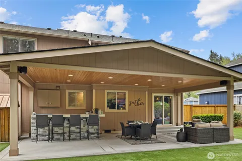 a view of a patio with couches chairs and a yard