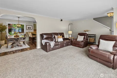a living room with furniture and a lamp