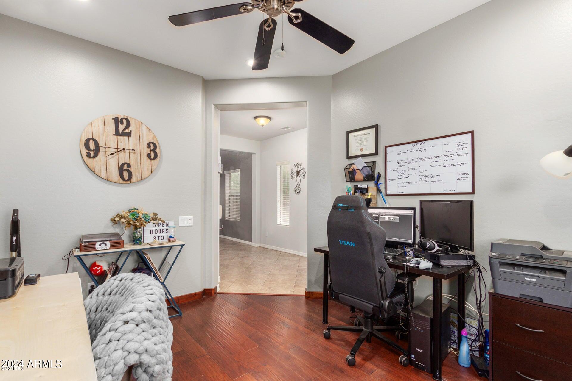 2217 West Kathleen Road Phoenix, AZ 85023 - Photo 14 of 42 a view of a workspace with furniture and a ceiling fan