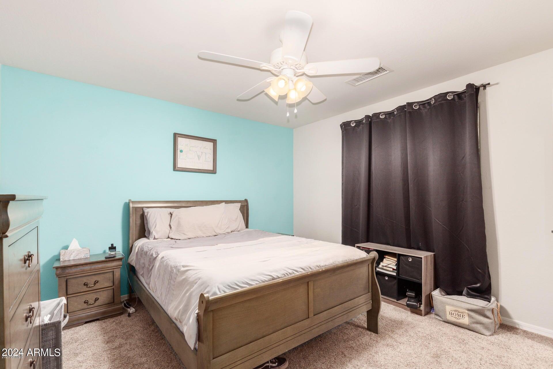 2217 West Kathleen Road Phoenix, AZ 85023 - Photo 16 of 42 a bedroom with a bed and a chandelier