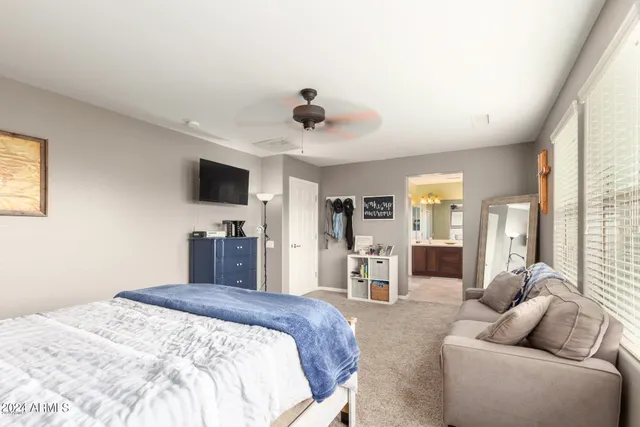 a bedroom with furniture and a flat screen tv