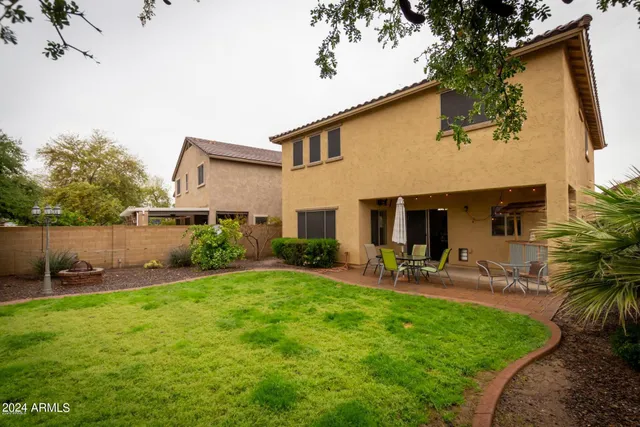 a view of a house with a yard and sitting area