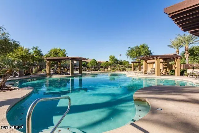 a view of swimming pool with outdoor seating