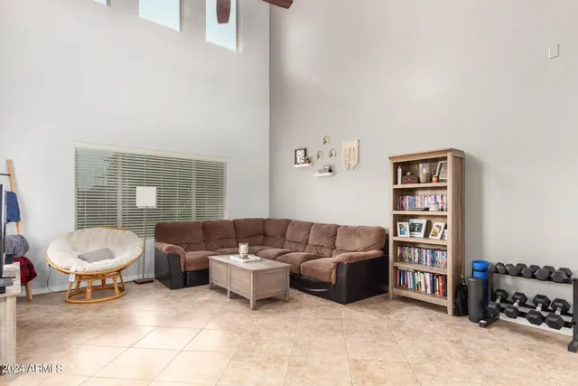 a living room with furniture and a book shelf