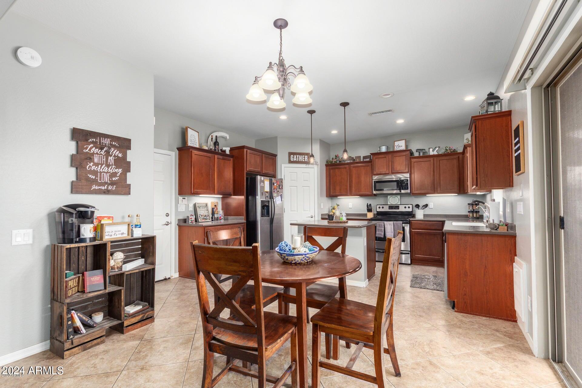 2217 West Kathleen Road Phoenix, AZ 85023 - Photo 9 of 42 a view of a dining room with furniture