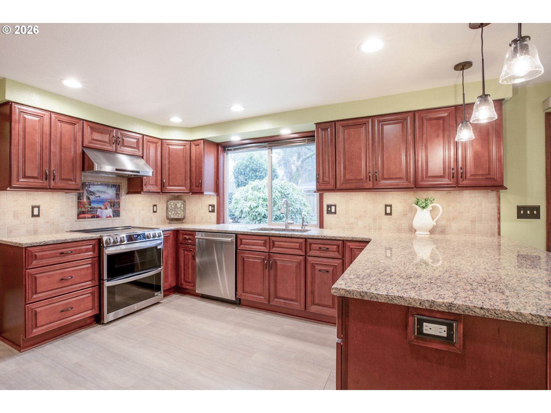 475 Banton Avenue Eugene, OR 97404 - Photo 12 of 34 a kitchen with kitchen island granite countertop wooden cabinets a stove a sink and dishwasher