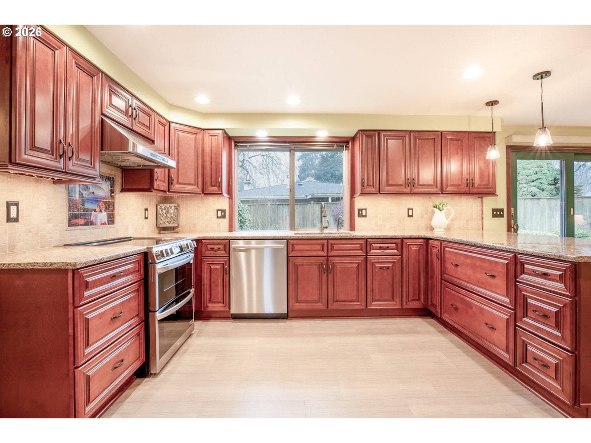 475 Banton Avenue Eugene, OR 97404 - Photo 14 of 34 a kitchen with stainless steel appliances granite countertop a stove a sink dishwasher and a refrigerator
