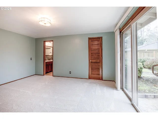 an empty room with windows and closet