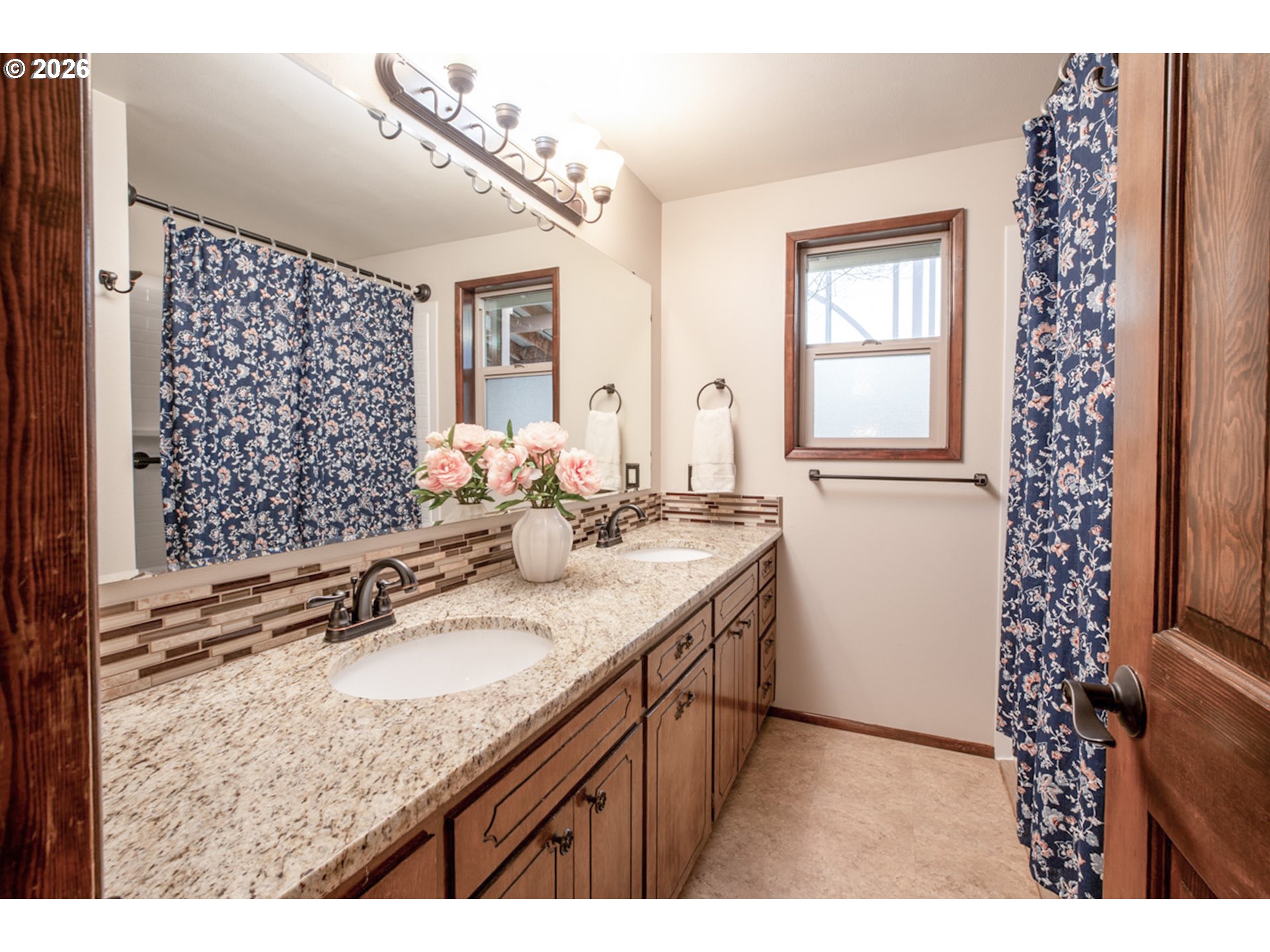 475 Banton Avenue Eugene, OR 97404 - Photo 21 of 34 a bathroom with a granite countertop sink a mirror a vanity and a shower