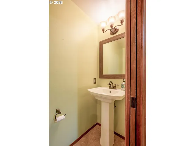 a bathroom with a sink a mirror and bathtub