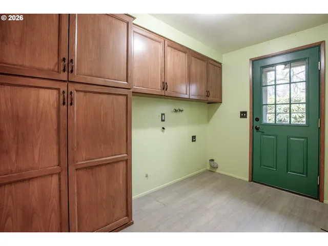 a kitchen with cabinets and wooden floors