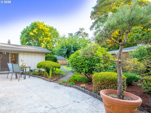 a view of a house with backyard and patio