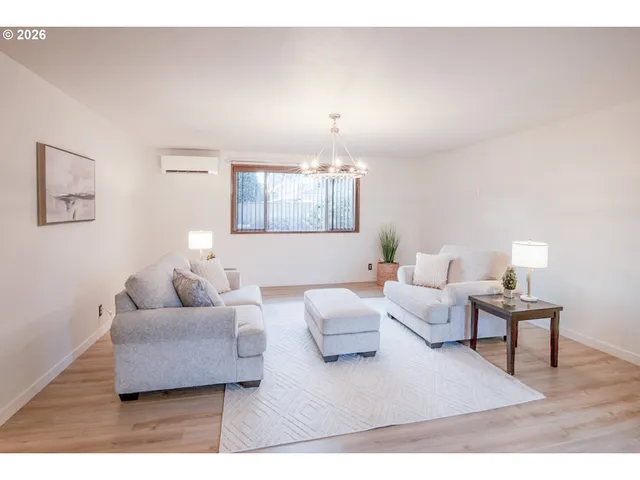a living room with furniture and a lamp