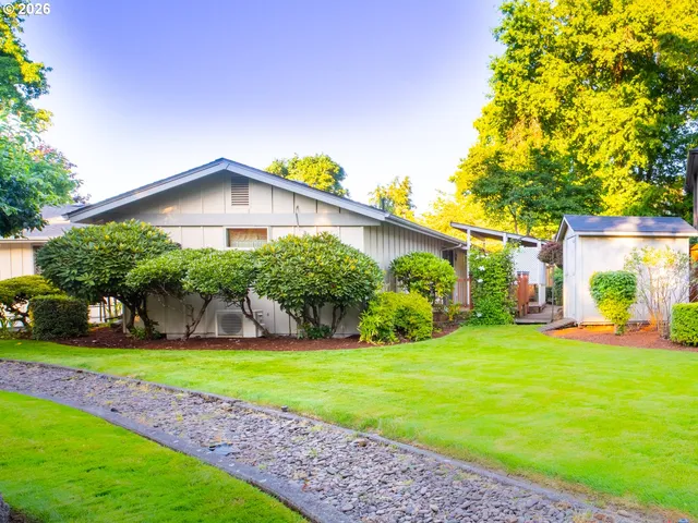 a view of a house with a yard and plants