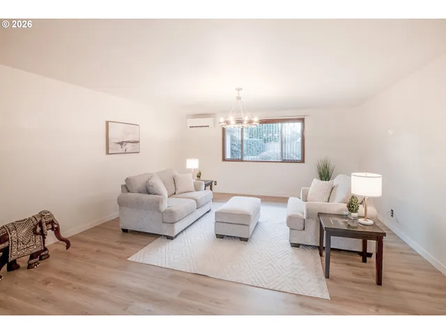 a living room with furniture and a lamp