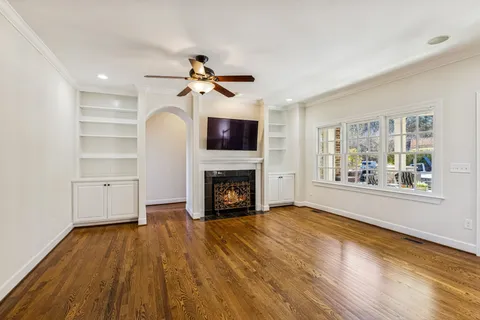 a kitchen with stainless steel appliances kitchen island granite countertop a sink a stove a dining table and chairs