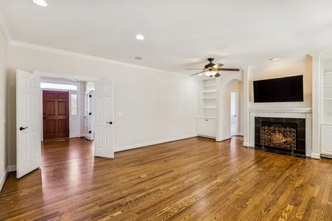 a kitchen with stainless steel appliances kitchen island granite countertop a stove a sink and a wooden floors